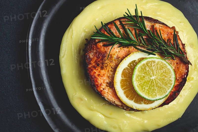 Salmon steak, fried, mashed potatoes, top view, rosemary, lemon and lime, homemade, one serving, no people