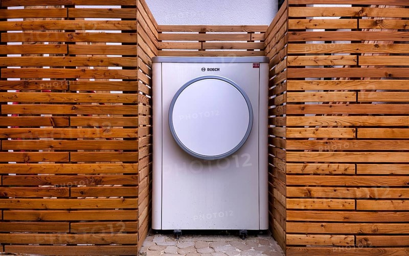 Bosch Compress 7400i AW air-to-water heat pump, logo, outdoor unit, building services, standing in front of garden fence, wooden fence, recess, Stuttgart, Baden-Württemberg, Germany, Europe