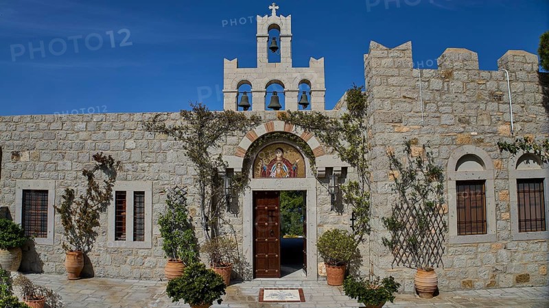 Church façade with bell tower and religious icon, surrounded by plants, woman's monastery, Evangelismou Monastery, Patmos, Dodecanese, Greek Islands, Greece, Europe