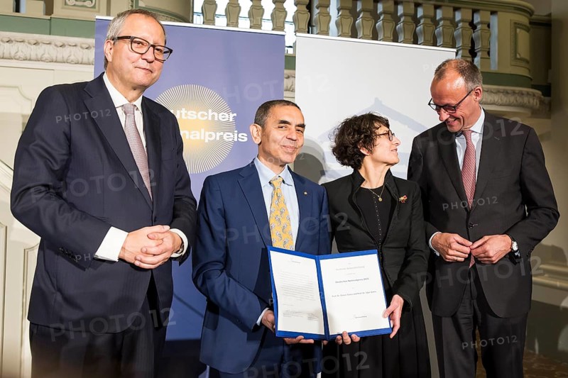 Thomas Mirow (Chairman of the Board of the German National Foundation), Ugur Sahin and Özlem Türeci (founders of Biontech SE) and Friedrich Merz (Chancellor of the Federal Republic of Germany) at the award ceremony for the German National Prize 2025 in the Französische Friedrichstadtkirche, Berlin, on 10 June 2025