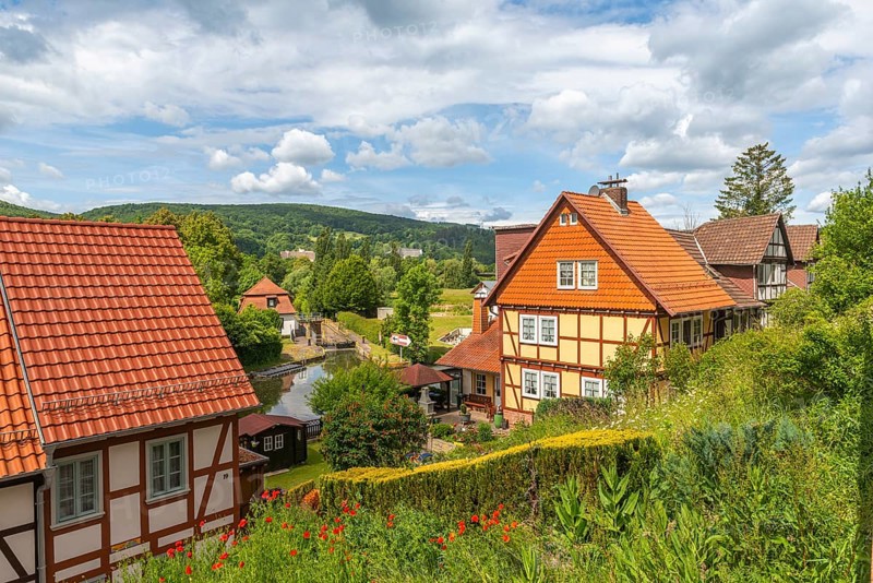 Lock system of the Werra with lock house, old fishermen's settlement, Bad Sooden, Allendorf, district Allendorf, street Fischerstad under monument protection, garden, half-timbered houses, low mountain range, forest, slope, blooming red poppy, blue sky, clouds, Werra-Meissner-Kreis, Hesse, Germany, Europe