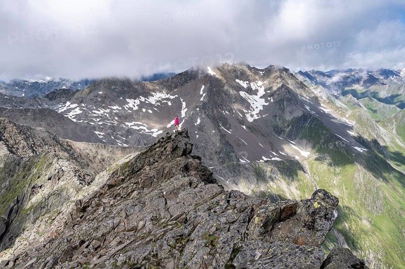Hiker on a rock, Lasörling Höhenweg, Lasörling Group, Hohe Tauern National Park, East Tyrol, Tyrol, Austria, Europe