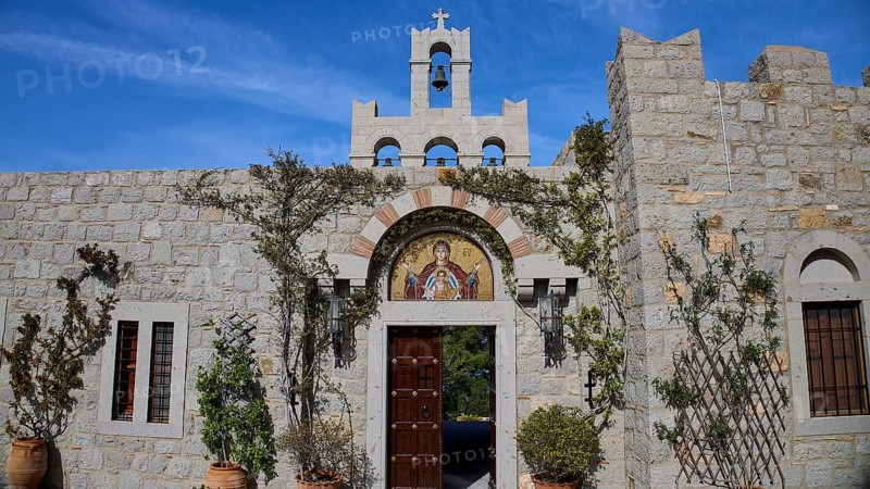 Stone building with bell tower and religious mosaic, surrounded by climbing plants, woman's monastery, Evangelismou Monastery, Patmos, Dodecanese, Greek Islands, Greece, Europe