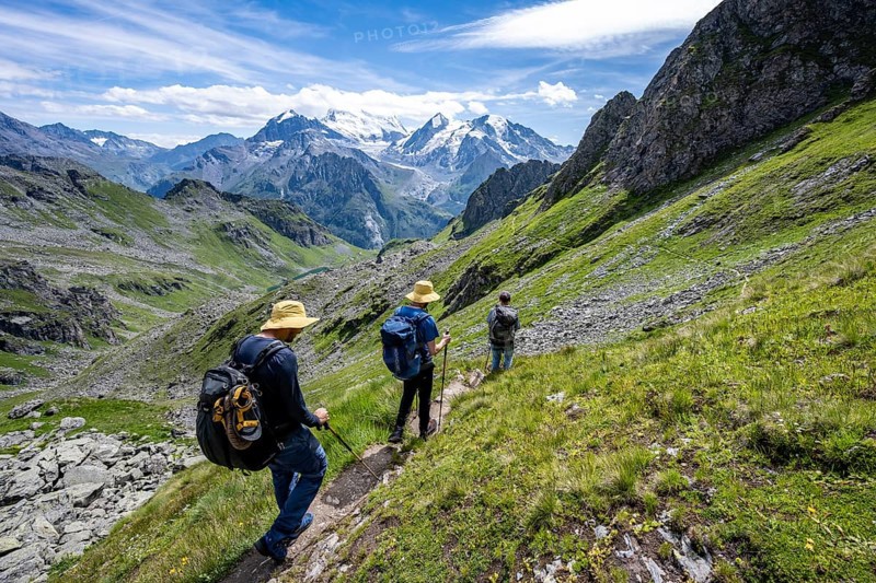 Mountaineer on hiking trail in mountain landscape, descent at Col du Louvie, view of glaciated mountain peaks of the Grand Combine, Valais Alps, Val de Bagnes, Valais, Switzerland, Europe