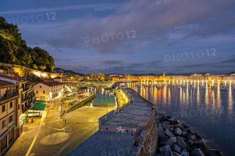 The port of San Sebastian with the city in the background at night