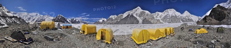 Scenic panorama of tents on Engilchek glacier in picturesque Tian Shan mountain range in Kyrgyzstan