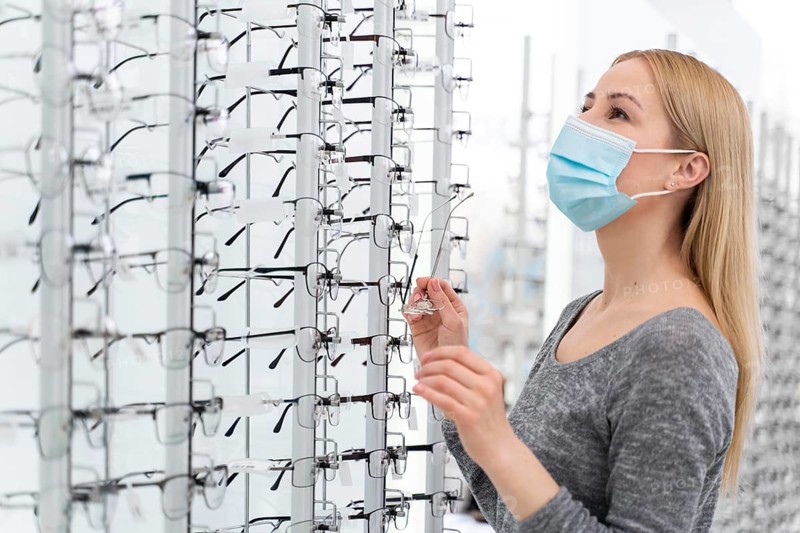 Woman with mask store trying glasses 4