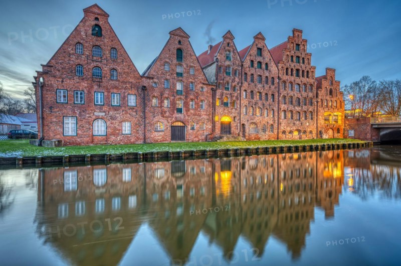 The historic salt warehouse with the river Trave at dawn, seen in Lübeck, Germany, Europe