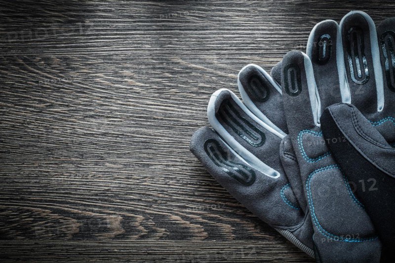 A pair of protective gloves on a wooden board