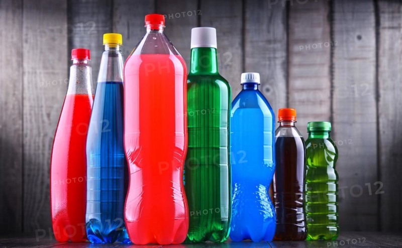 Plastic bottles of assorted carbonated soft drinks in variety of colors