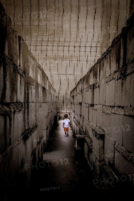 Caucasian young kid walking with labyrinth perspective. Conceptual image for dangerous situation during childhood