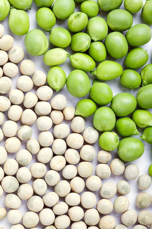 Fresh green and dried peas with cropping frame on white background