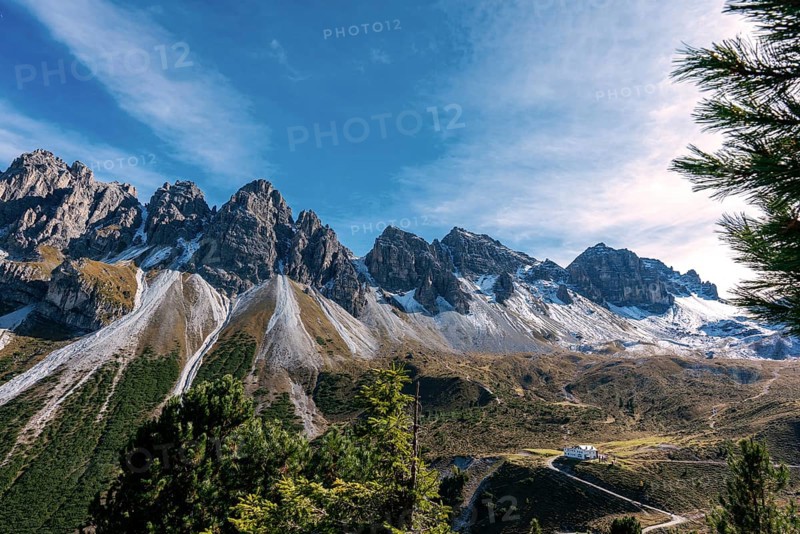 View at the Senders valley and Adolf Pichler mountain hut near Kemater Alm in Austria with high rising mountains (Kalkkoegel) in the background