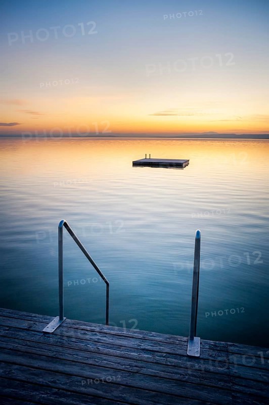 Sunset at Weiden on the lake with ladder and swimming island