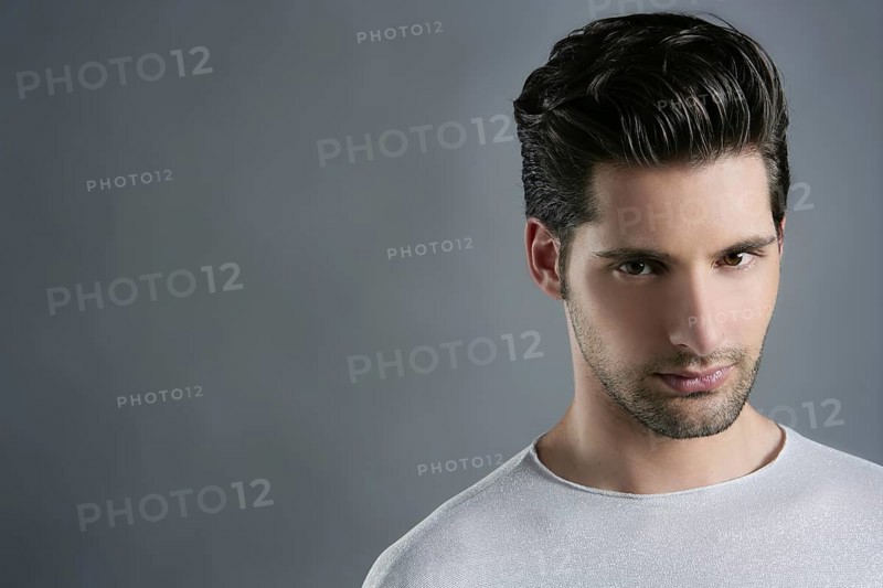 Fashion trendy young man silver futuristic portrait over gray