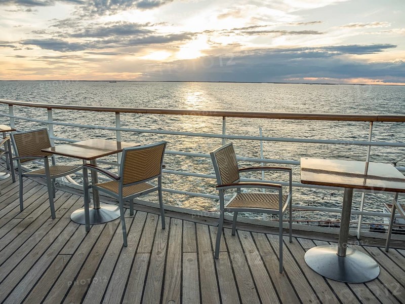 Terrace on the sea at sunset, empty tables and chairs, quiet atmosphere, svaneke, bornholm, baltic sea, denmark, scandinavia