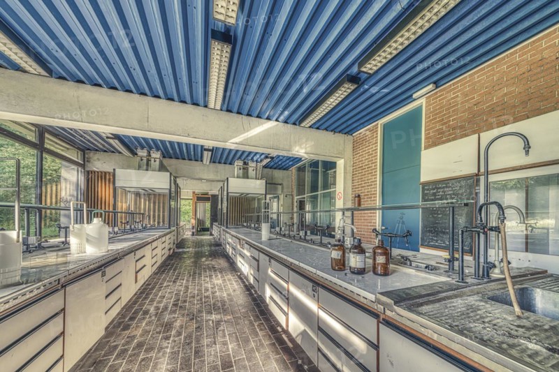 An abandoned laboratory room with long benches and glass containers under daylight, Institute of Molecular Biology, Lost Place, Sint-Genesius-Rode, Province of Flemish Brabant, Belgium, Europe