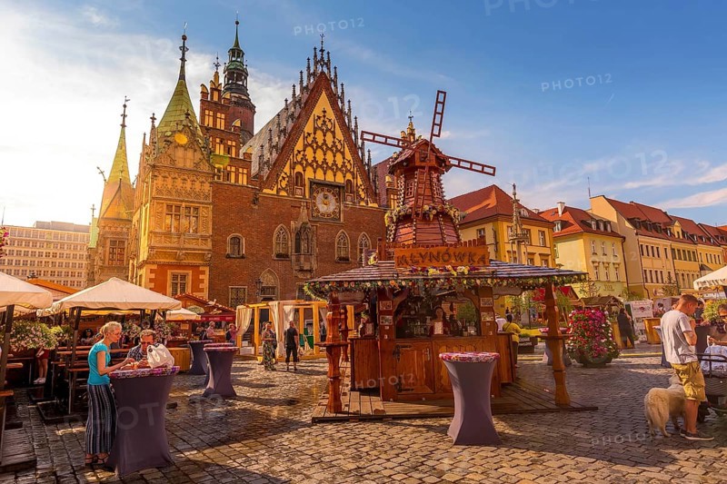 Wroclaw, Poland, June 21, 2019: Old Town Hall and decorative windmill at Market Square, stalls with food and drinks, people, Europe