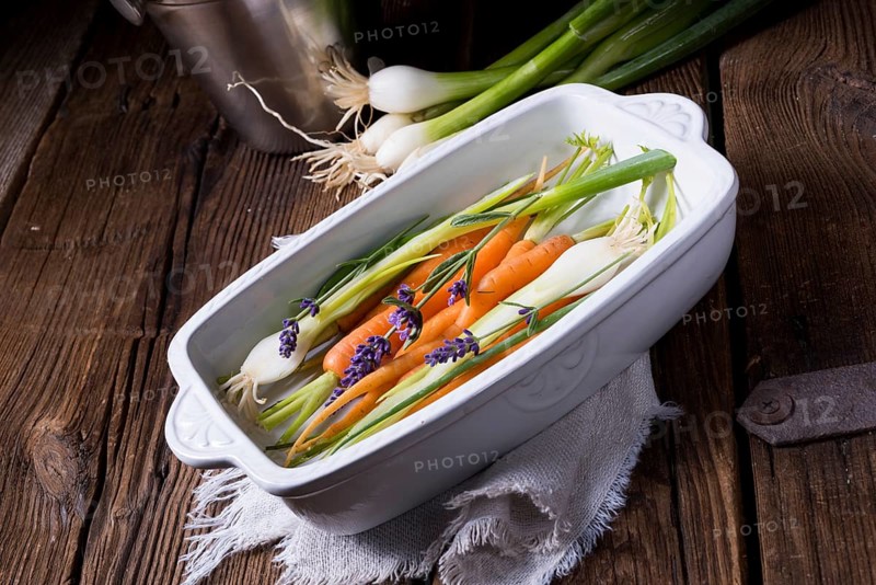 Young carrots and spring onions prepared for baking