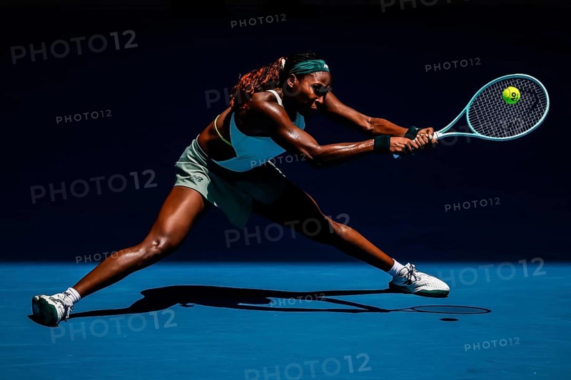 MELBOURNE, AUSTRALIA - JANUARY 19: Coco Gauff of USA hits a backhand to Belinda Bencic of Switzerland on day eight of the 2025 Australian Open at Melbourne Park on January 19, 2025 in Melbourne, Australia, Oceania