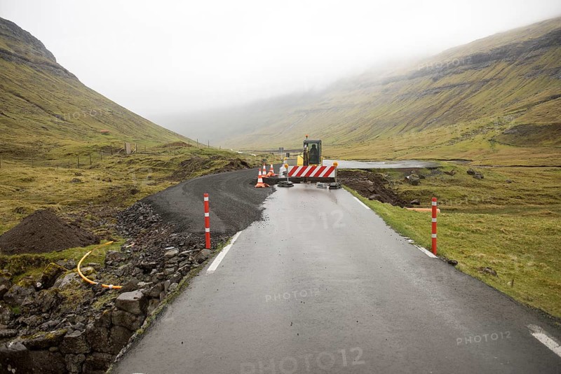 Road construction site on the Faroe Islands with road block sign and digger, Streymoy, Faroe Islands, Denmark, Europe