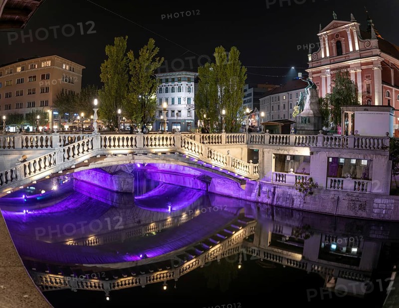 Famous three bridges at the Preseren square in the center of Ljubljana colorfully illuminated at night, Slovenia, Europe