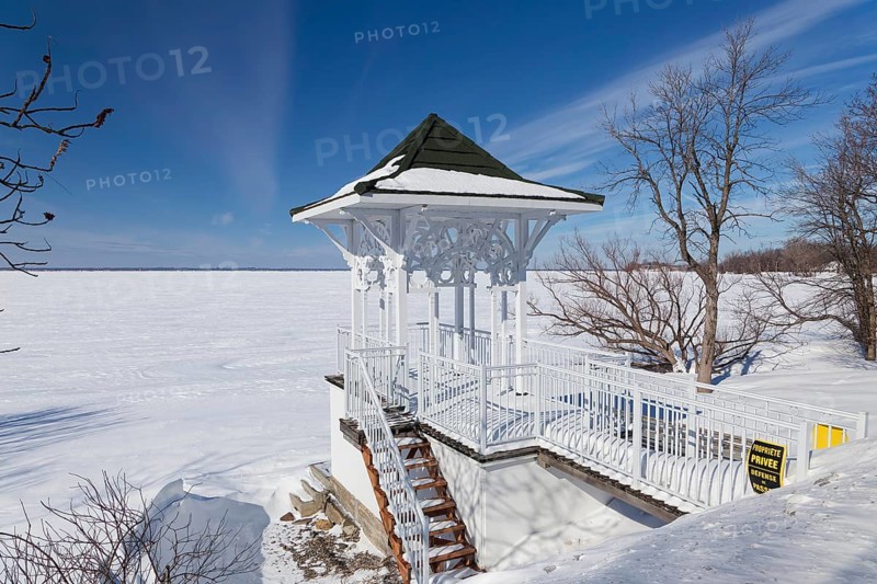 Winter, small private pavilion next to the snow and ice covered Saint Lawrence River, Lery, Province of Quebec, Canada, North America