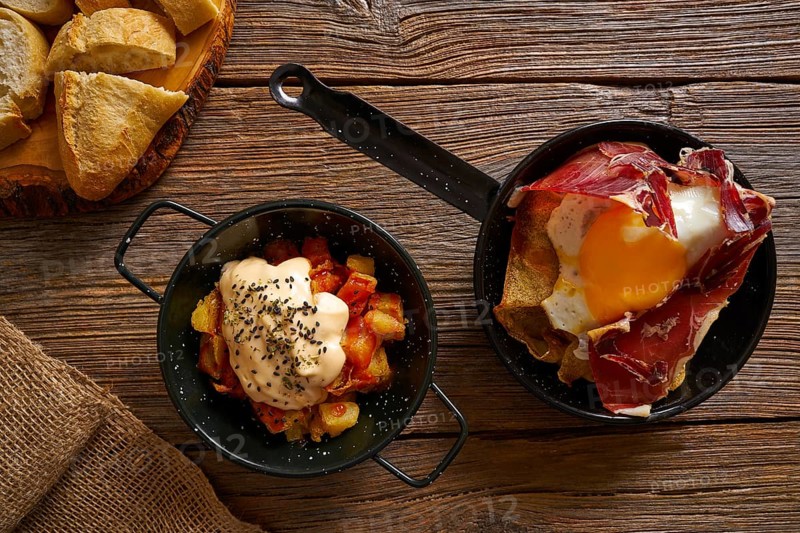 Tapas from spain broken eggs and bravas potatoes
