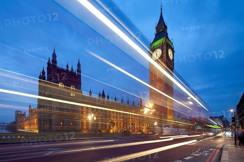 Big Ben in the evening. Dabldekker passes and leaves a line of light at slow shutter speeds. Cityscape shot with tilt-shift lens maintaining verticals