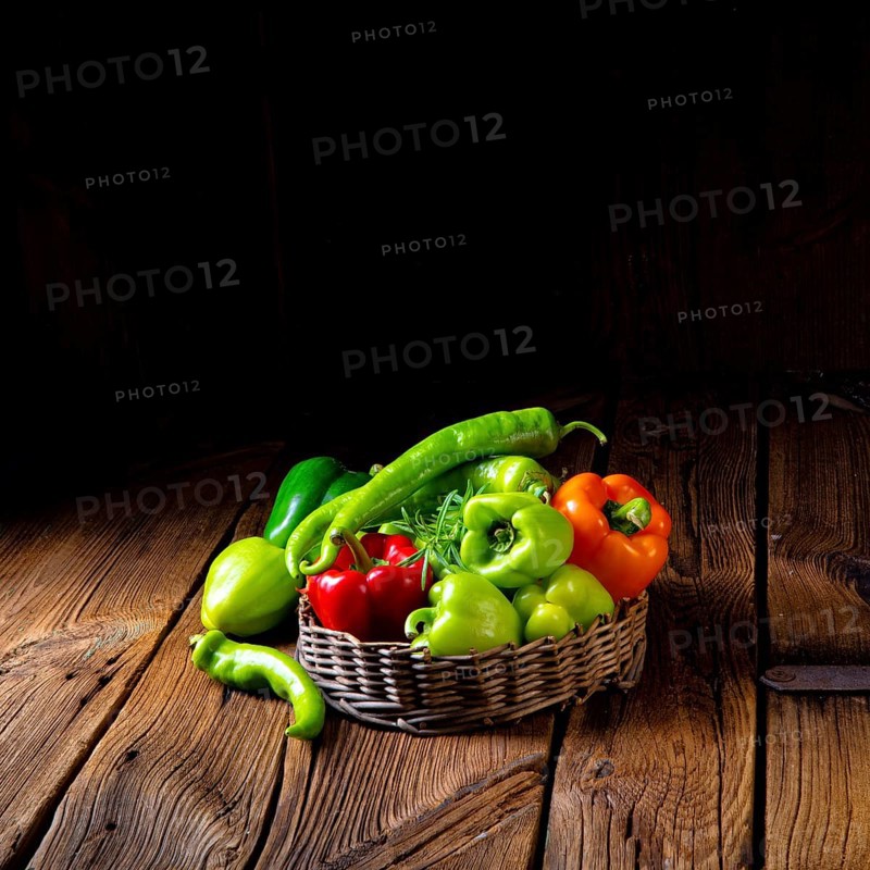 Various harvested peppers and hot peppers in basket