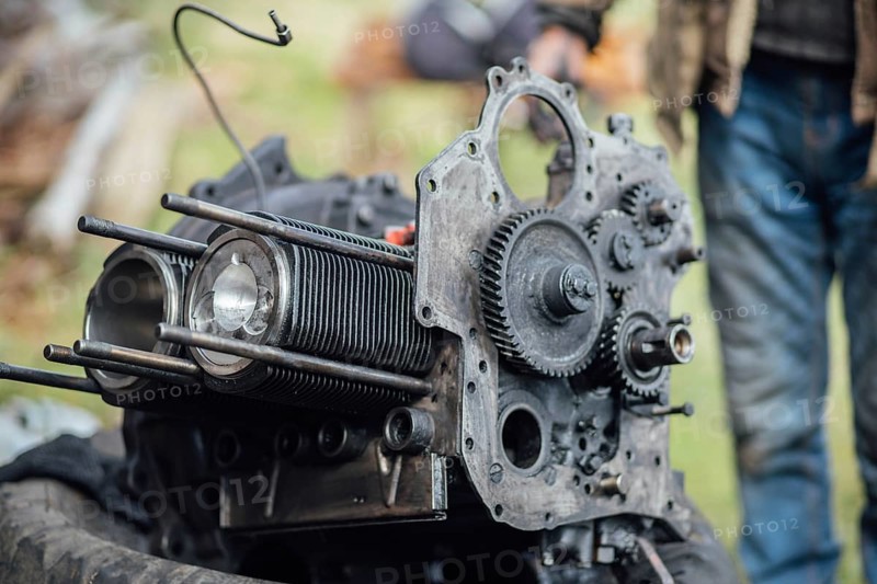 View of mechanical parts of an engine being repaired outside