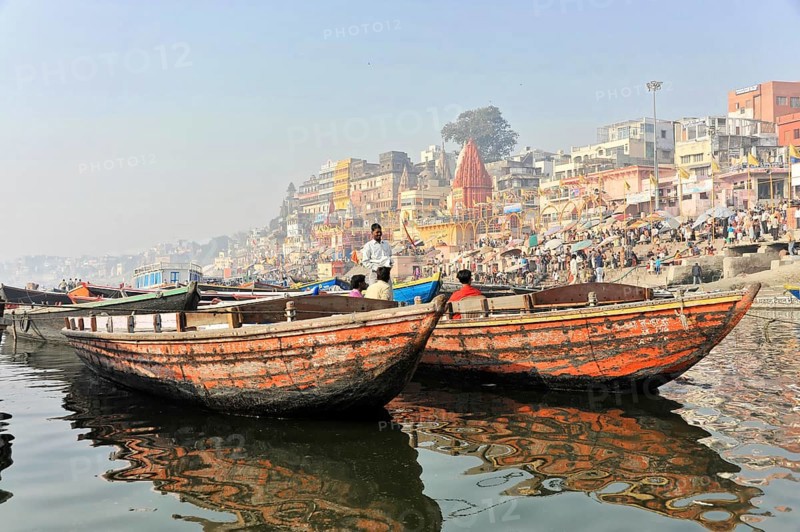 Varanasi, Uttar Pradesh, India, Asia, Two boats floating side by side on a river with urban scenery in the background, Asia