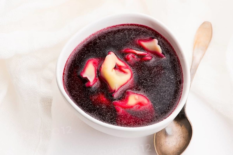 Christmas beetroot soup, borscht with small dumplings with mushroom filling