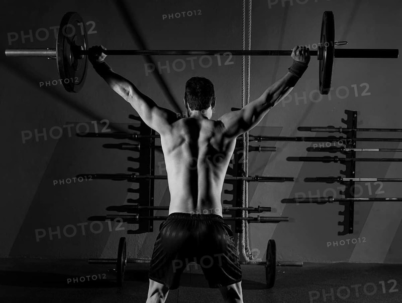 Barbell weight lifting man rear view back workout exercise at gym box