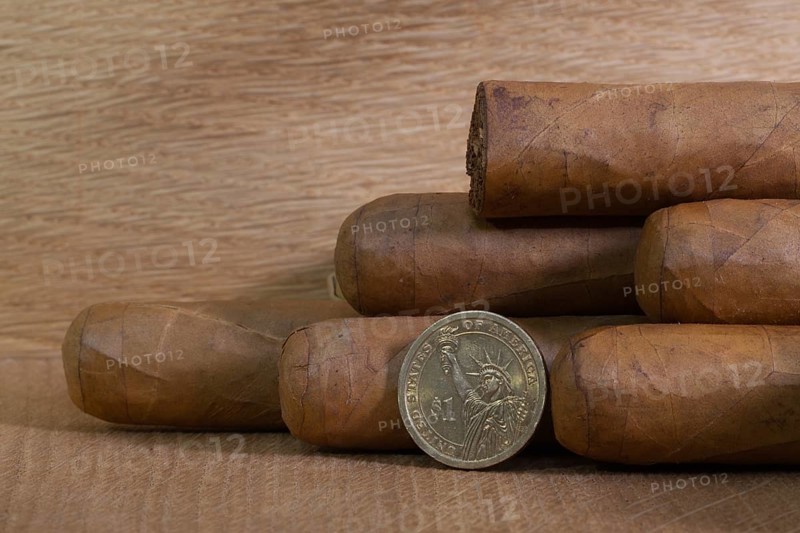 Luxury Cuban cigars with US dollar on the wooden table
