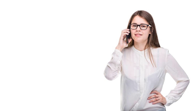 Smiling businesswoman in glasses talking on mobile phone. Beautiful young girl in white shirt on white isolated background talking on mobile phone. Woman in shirt with cellphone. Copy space. Blank