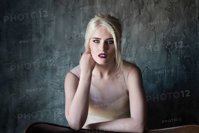 Portrait of beautiful young woman on dark background