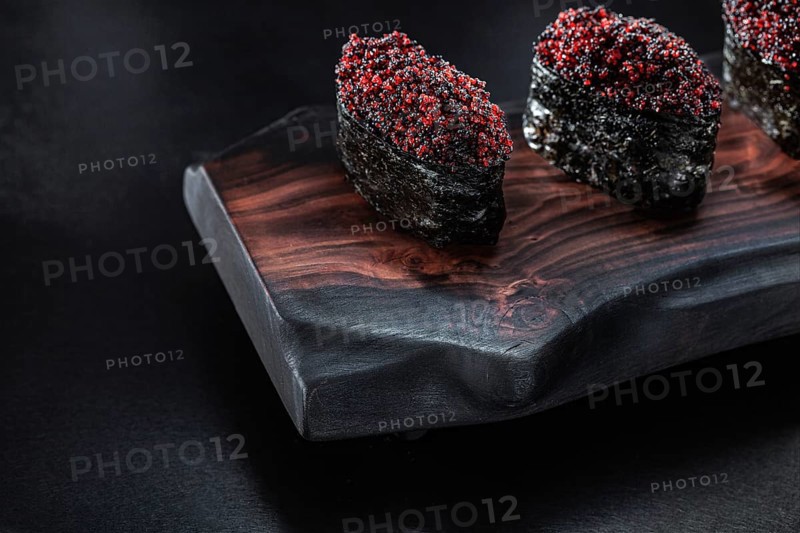 Close Up View Gunkan Maki Sushi On Dark Wooden Board