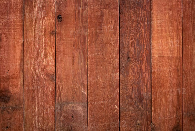 Red weathered barn wood background with knots and nail holes