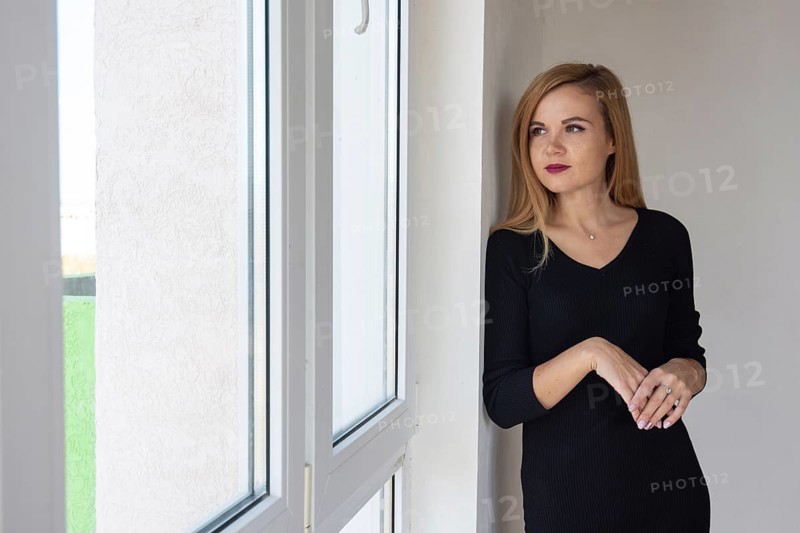 Beautiful girl looks in a new apartment in a new building