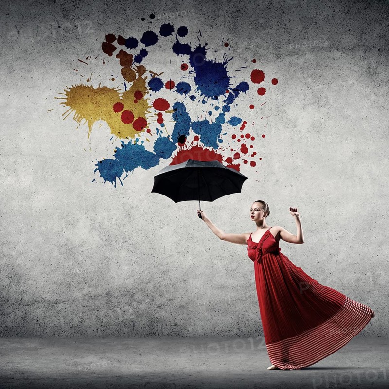 Passionate woman dancer in red dress with black umbrella in hand