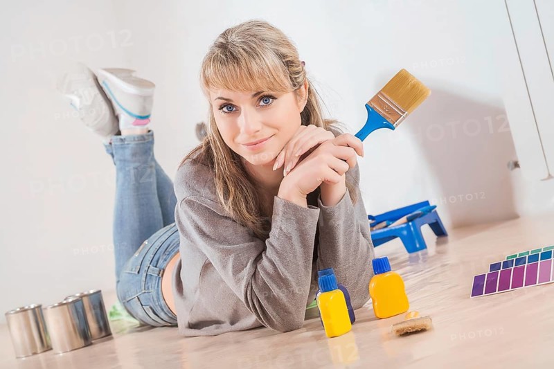 Beautiful housewife painting at home
