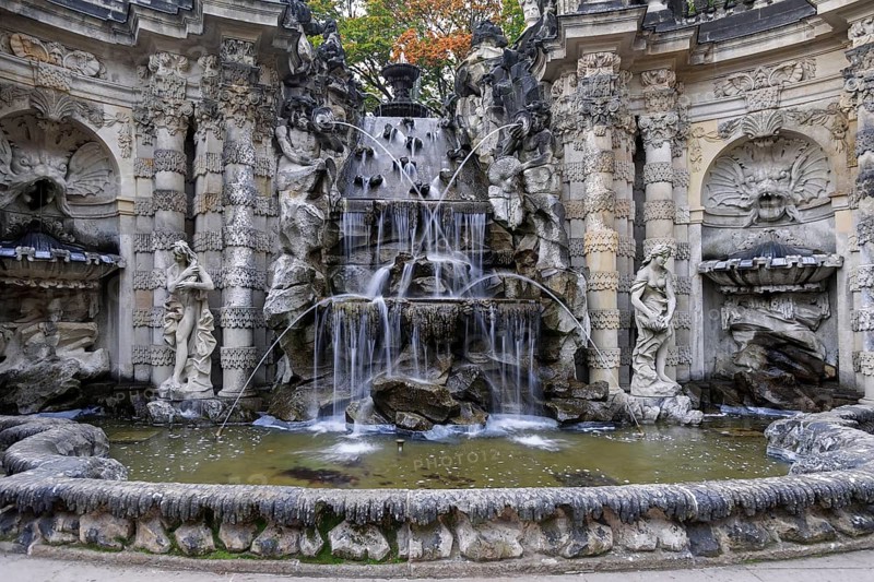 Fountain with faunus statues and streaming water at Zwinger palace, Dresden, Germany, Europe