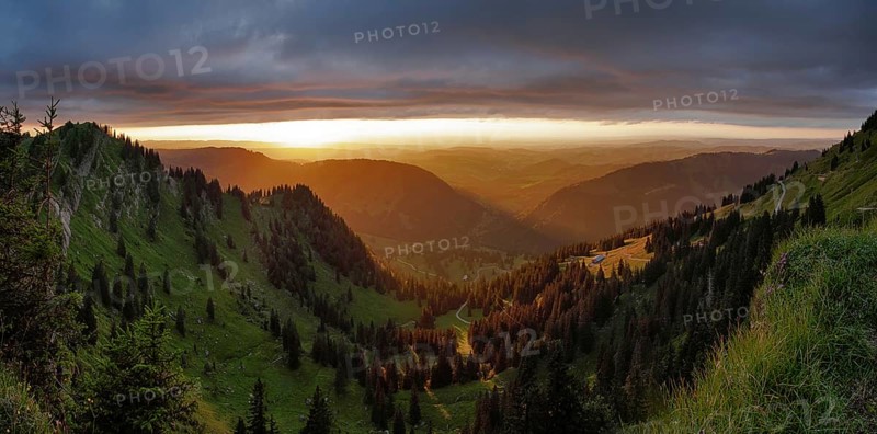 Panoramic view of a light and weather scene over the foothills of the Alps, taken from the Nagelfluhkette, Allgäu. In the centre in the background Oberstaufen and on the left the Seelekopf