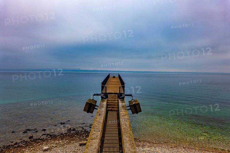 Waterfront and a Pier on Lake Neuchatel in Old Town in a Foggy Winter day in City of Neuchatel, Canton Neuchatel, Switzerland, Europe