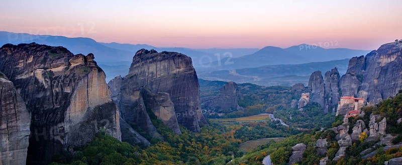Panoramic view of majestic rock formations and a valley with a monastery at dusk, Meteora valley with monasteries, Trikala, Thessaly, Greece, Europe