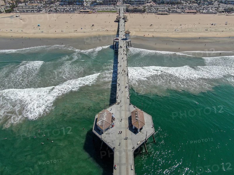 Aerial view of Huntington Pier, beach and coastline during sunny summer day, Southeast of Los Angeles. California. destination for surfer and tourist