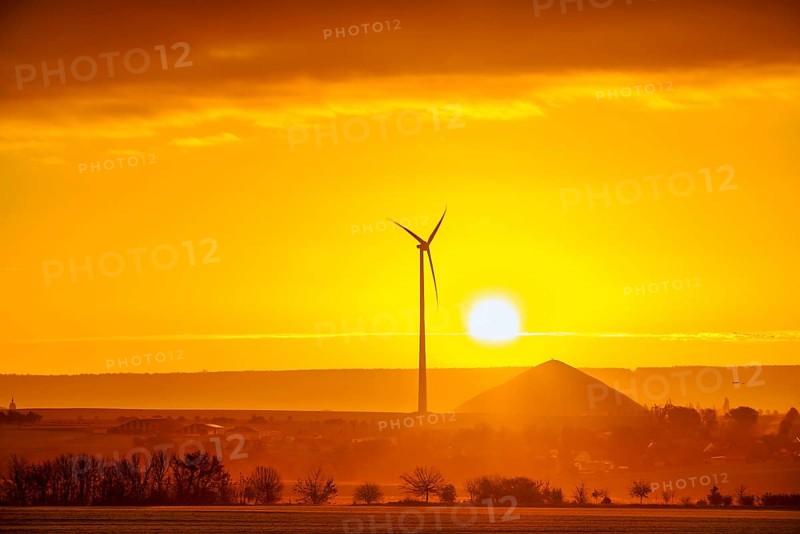 Sunrise with a view of wind turbines and mining heaps from the copper mines in the south of the Harz Mountains