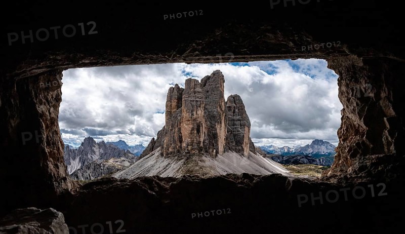 View out of an old military tunnel window towards the iconic Three Peaks mountain in the Dolomite Alps, former Austrian-Italian front in the First World War, Autonomous province of South Tirol