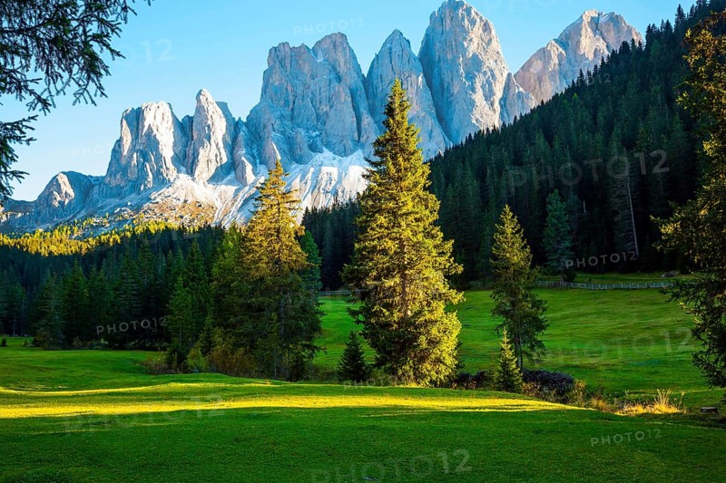 Italy. Majestic Dolomites. Powerful mountain peaks surround the piicturesque green valley Val di Funes. The concept of active, ecological and photo tourism